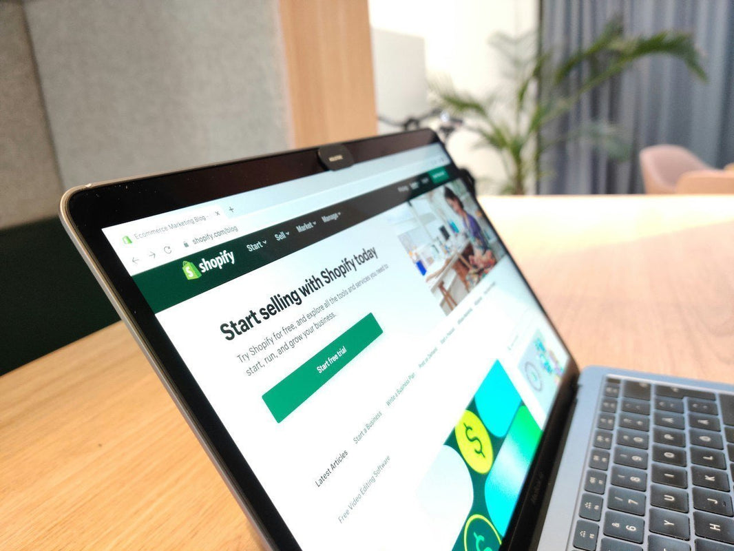 Person submitting a DMCA takedown notice on a Shopify store via laptop